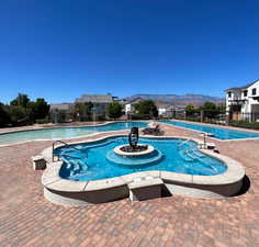 View of swimming pool featuring a mountain view and a patio area