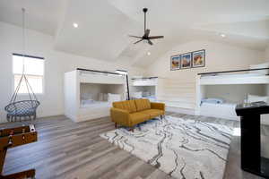 Bedroom with lofted ceiling and wood-type flooring