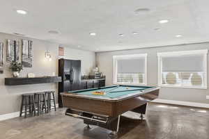 Playroom featuring concrete floors, pool table, and sink