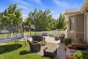 View of patio / terrace with a trampoline and grilling area