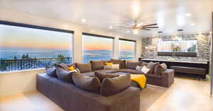 Living room with light wood-type flooring, plenty of natural light, a water view, and ceiling fan