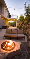 Exterior space featuring an outdoor living space with a fire pit