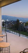 Balcony at dusk featuring a mountain view