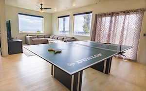 Playroom with light wood-type flooring and ceiling fan