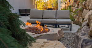 View of patio / terrace featuring an outdoor living space with a fire pit