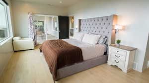 Primary bedroom with light wood-type flooring