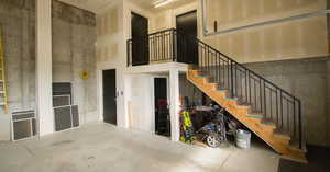 Stairway with a high ceiling and concrete flooring