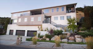 View of front facade with a garage and a balcony