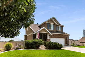 Craftsman-style home with a garage and a front yard