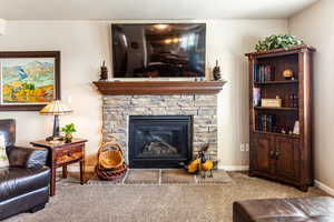 Carpeted living room with a fireplace