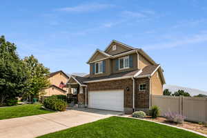 Craftsman house with a front yard and a garage