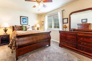 Bedroom with ceiling fan and carpet