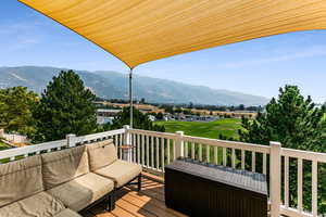 Wooden deck featuring outdoor lounge area and a mountain view