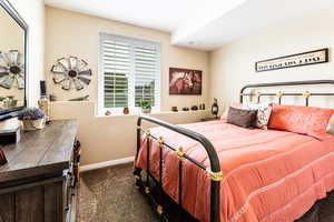 Bedroom featuring dark carpet