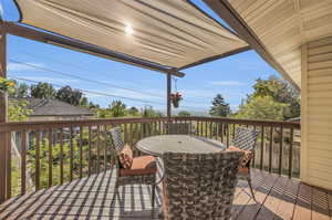 Shade covered deck with retractable vertical shades