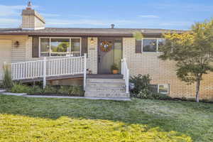 Ranch-style house featuring a front lawn