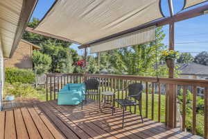 Shade covered deck with retractable vertical shades