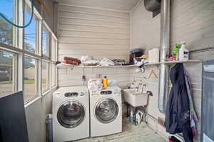 Laundry room with washer and clothes dryer