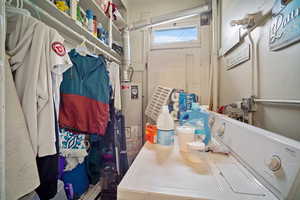 Interior space featuring gas water heater and separate washer and dryer