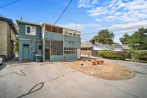 View of front of house with a garage and a sunroom