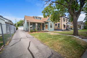 View of front of property featuring a front yard and covered porch