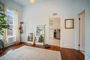 Interior space with dark hardwood / wood-style floors