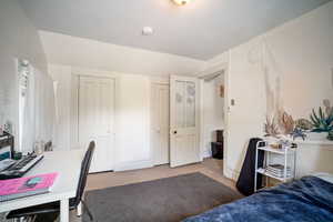 Carpeted bedroom with two closets