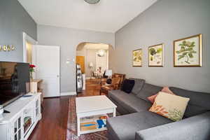 Living room featuring a textured ceiling and dark hardwood / wood-style flooring