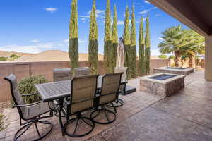 View of patio with a fire pit