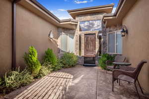 View of exterior entry featuring a patio