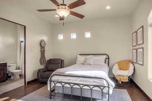 Bedroom featuring dark hardwood / wood-style flooring, connected bathroom, and ceiling fan