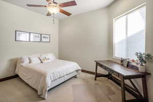 Bedroom featuring light carpet and ceiling fan