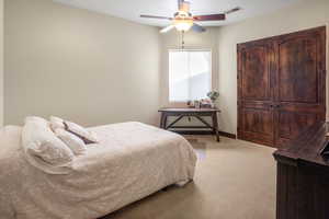 Bedroom with carpet flooring and ceiling fan