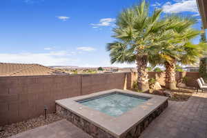 View of swimming pool featuring a patio area and an in ground hot tub