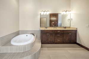 Bathroom with vanity and a relaxing tiled tub