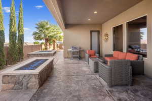 View of patio / terrace with a grill and an outdoor living space with a fire pit