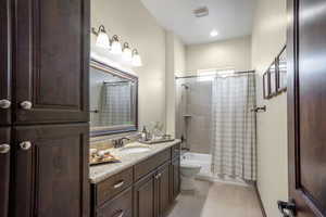 Full bathroom featuring vanity, toilet, and shower / bath combo with shower curtain