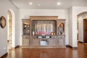 Bar featuring dark hardwood / wood-style floors