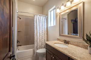 Full bathroom with vanity, toilet, and shower / tub combo