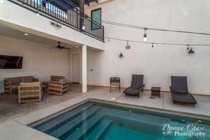 View of swimming pool with ceiling fan