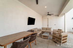 View of patio with an outdoor living space and ceiling fan