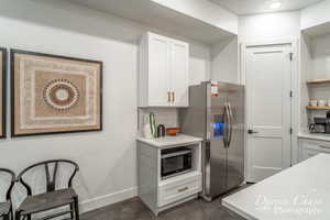 Kitchen featuring white cabinets and stainless steel appliances