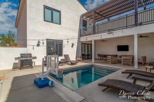 View of swimming pool featuring a patio area, area for grilling, and outdoor lounge area