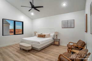 Bedroom featuring high vaulted ceiling, ceiling fan, and light wood-type flooring