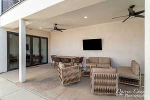 View of patio with an outdoor living space and ceiling fan