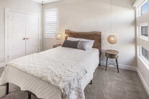 Bedroom with a closet and carpet flooring