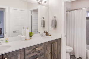 Full bathroom with vanity, toilet, and shower / tub combo with curtain