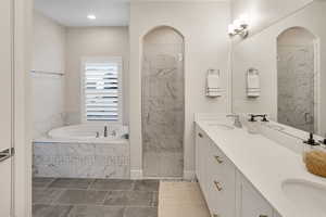 Bathroom featuring vanity, independent shower and bath, and tile patterned floors