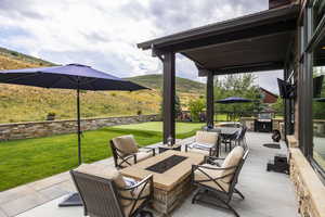 View of patio featuring a grill