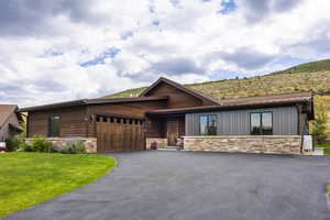 View of front of house featuring a garage and a front yard